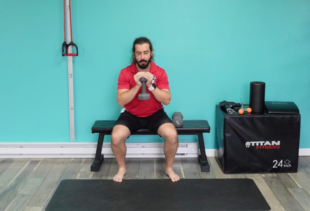 Dr. john doing a goblet squat to a bench as a beginner way to start improving this movement pattern